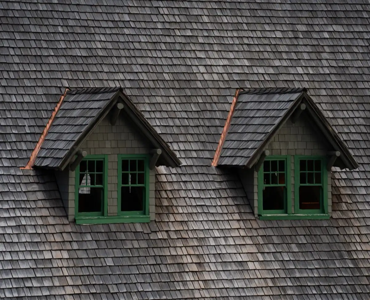 Dormers on a shingle roof in Tallahassee, FL, where step flashing and kickout flashing carry water past the walls