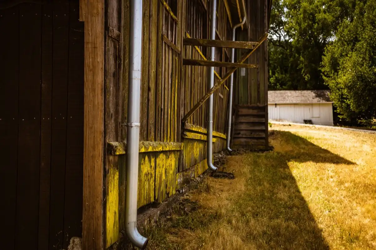 Roof edge, fascia and downspout on a house in Tallahassee, FL, where drip edge carries runoff into the gutter